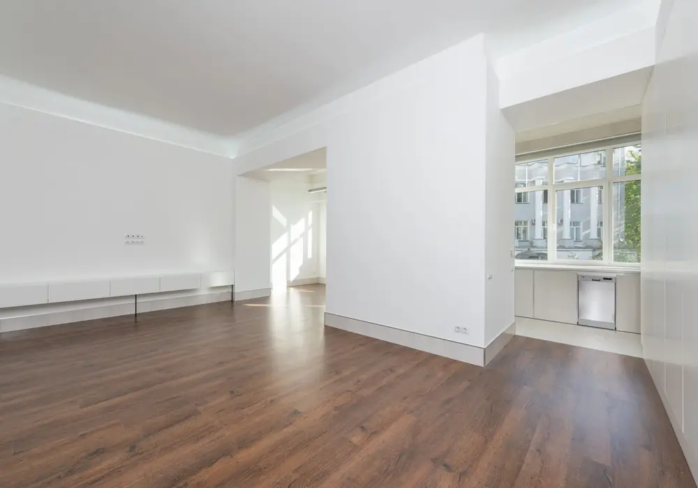 Restored white room with new wood flooring